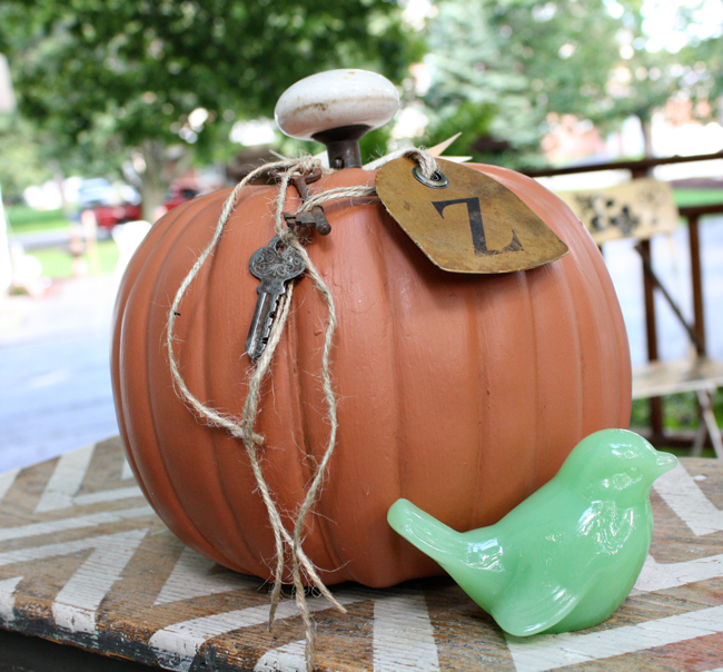 painted faux pumpkin with vintage door knob and map