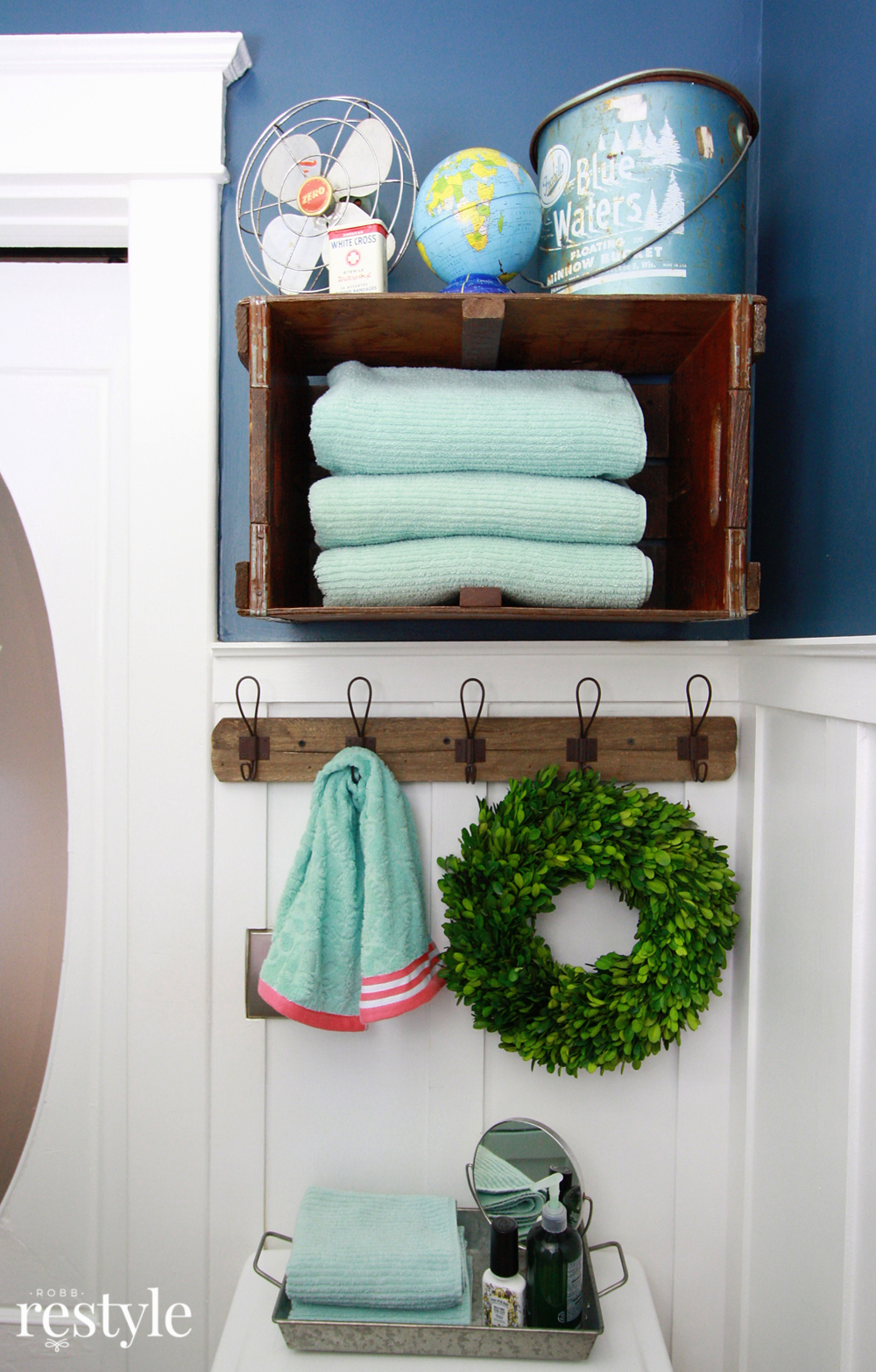 Turn a vintage crate on its side to store bathroom towels.